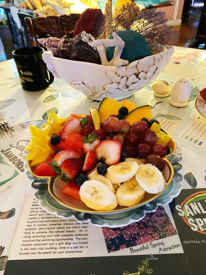 Fresh sliced fruit in bowl on table