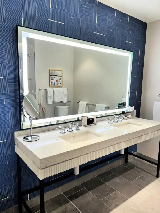 blue-bathroom-with-lighted-mirror